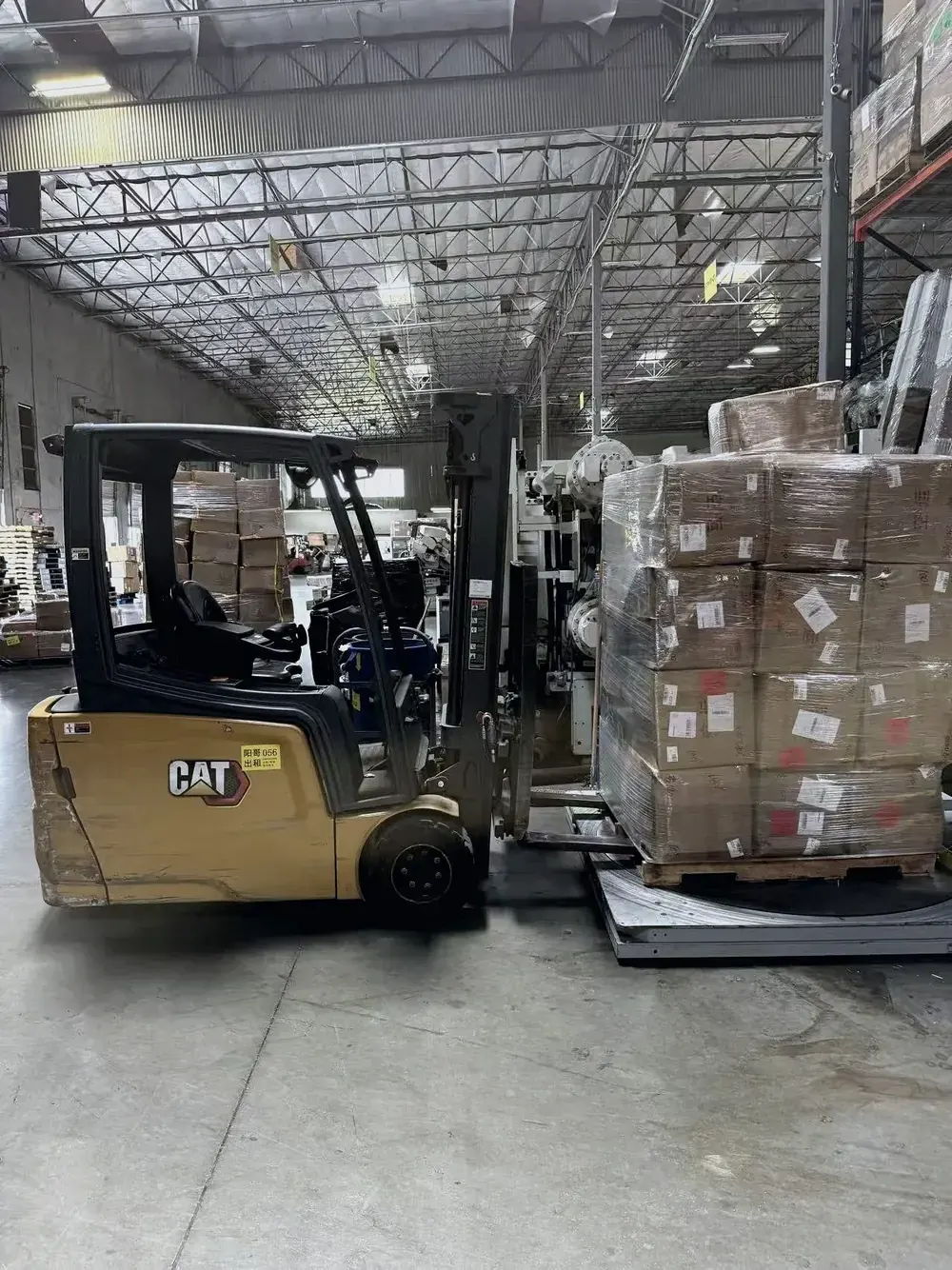 Palletized cargo staged beside a forklift