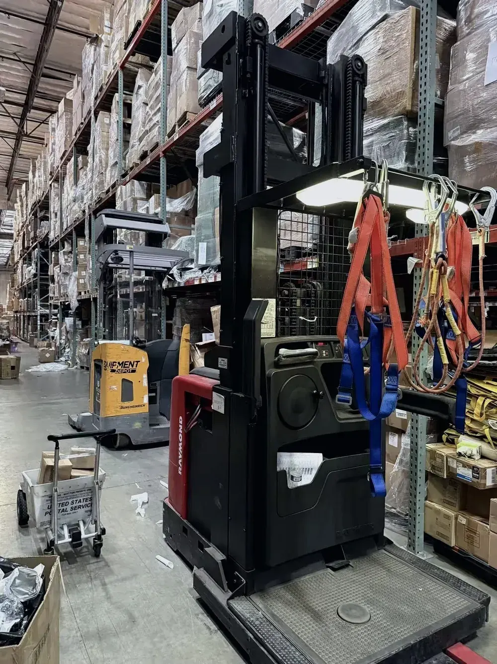 Forklift parked beside warehouse inventory